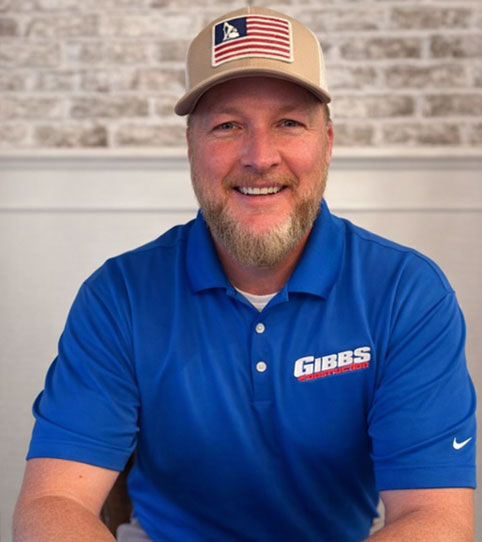Jason Gibbs, owner of Vinyl Windows by Gibbs in Woodstock, Georgia, smiling in a blue company polo and cap, showcasing a trusted exterior remodeling expert with 33 years of experience specializing in high-quality vinyl window installation and customer-focused service.