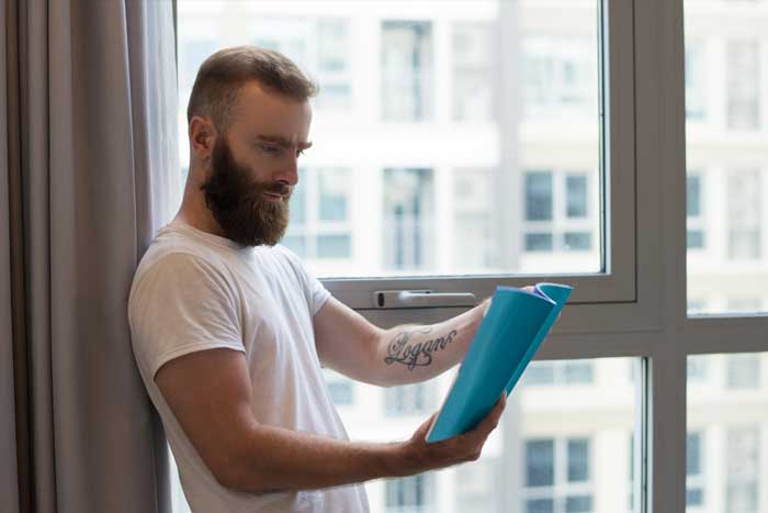 Interior bay window with white frames and decorative accents overlooking brick apartment buildings, enhancing natural light and city views while showcasing professional Window Replacement Atlanta services for modern, energy-efficient homes.
