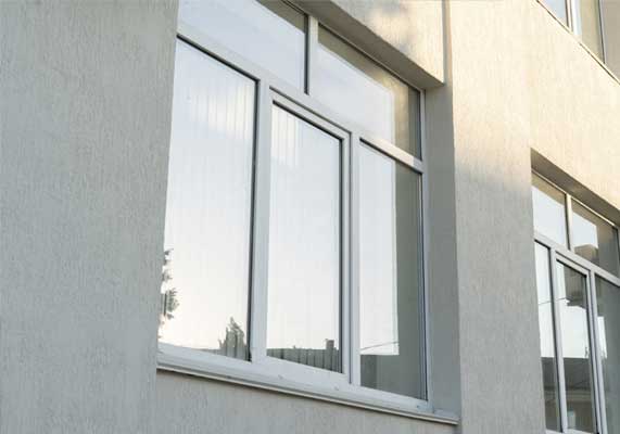 Window Replacement Dallas GA featuring sleek white replacement windows installed on a modern exterior wall, improving insulation, appearance, and home value