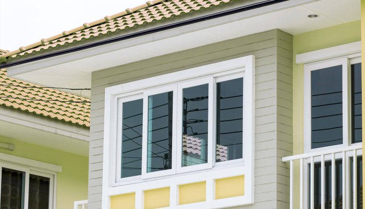 Home exterior with white-framed double hung windows on an upper level, featuring clean siding, modern trim, and enhanced curb appeal with professionally installed Double Hung Windows Atlanta for durability and energy efficiency.