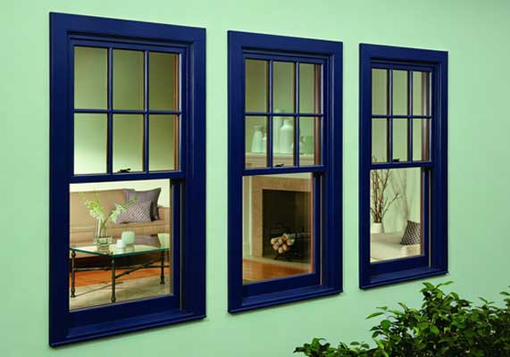 Window Replacement Woodstock with stylish blue-framed double-hung windows installed on a home exterior, showing modern window design and improved natural lighting inside the living space.